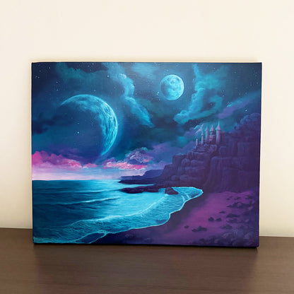 Original acrylic painting Moondrift Keep by Amy Denise featuring twin moons over a moonlit shoreline and a solitary stone keep on coastal cliffs