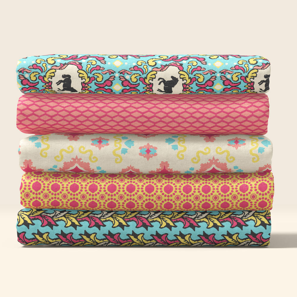 Folded fabrics from the coral colorway of the Carousel Pattern Collection